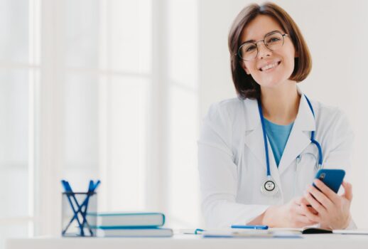 horizontal-view-of-smiling-professional-doctor-works-in-clinic-poses-at-modern-hospital-office-with-electronic-gadgets-4836x3024-2176x1361 horizontal-view-of-smiling-professional-doctor-works-in-clinic-poses-at-modern-hospital-office-with-electronic-gadgets-4836x3024-2176x1361