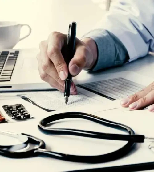 midsection-doctor-reading-paper-table-clinic-2-1